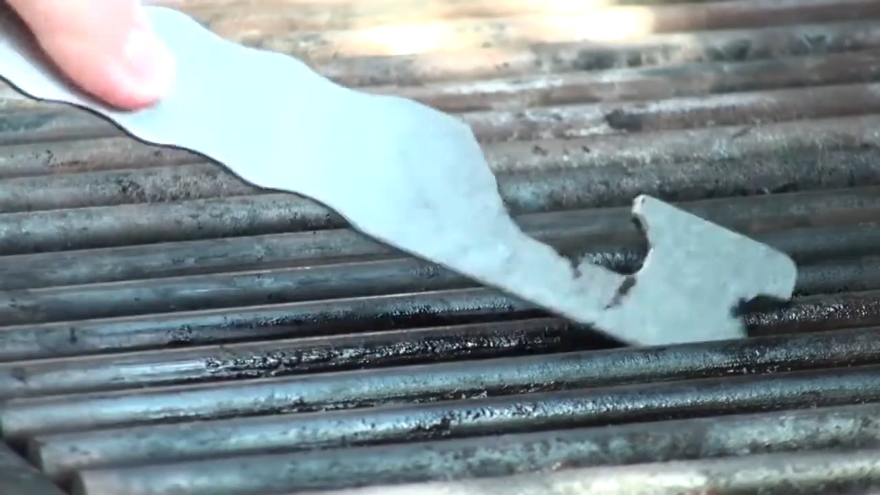 Close up of the BBQ Pic cleaning dirty grills of BBQ.